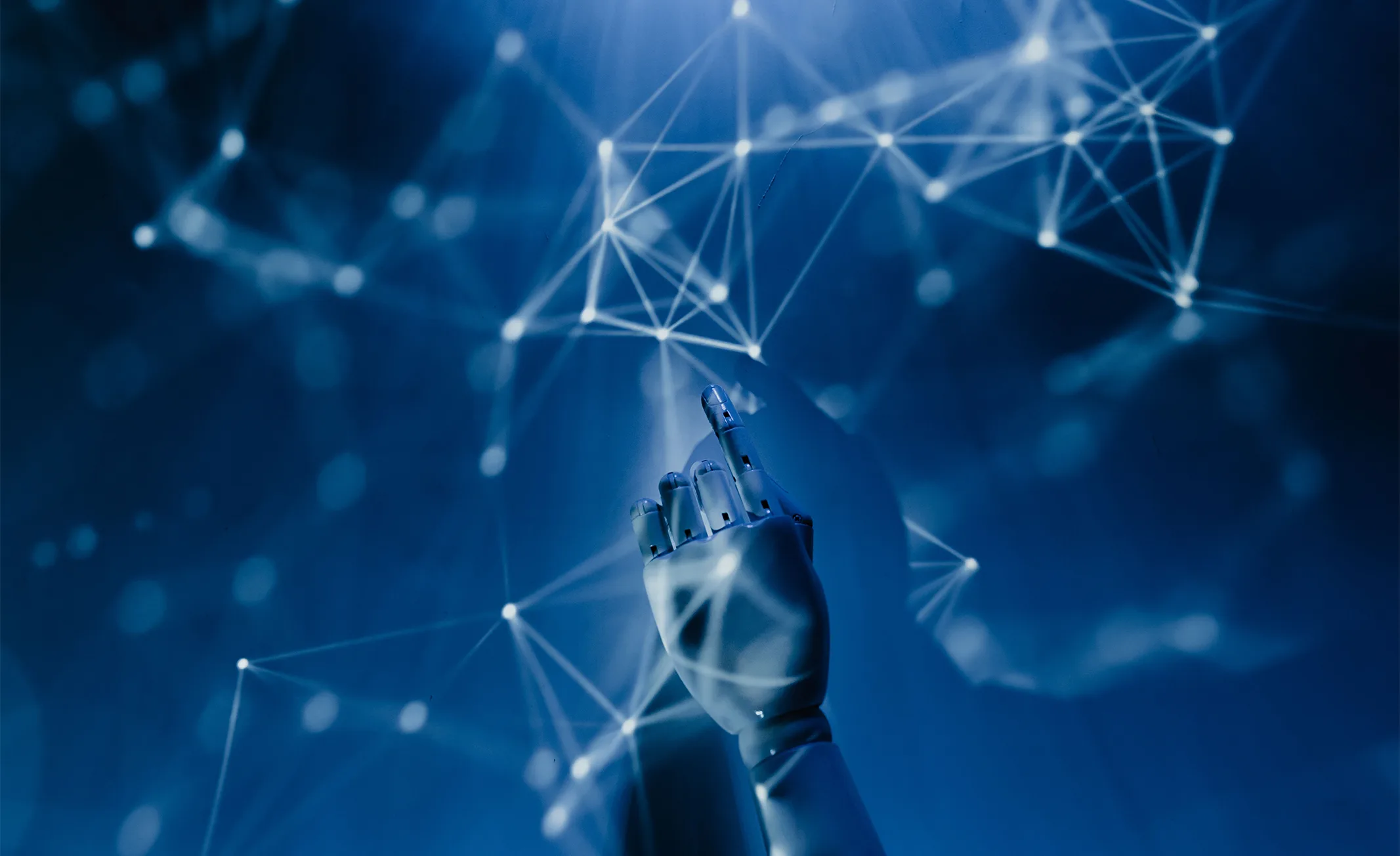Robotic hand touching a glowing digital network, symbolizing AI-driven technology.
